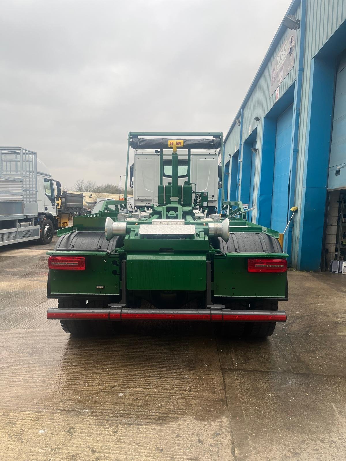 Green commercial hookloader after paintwork