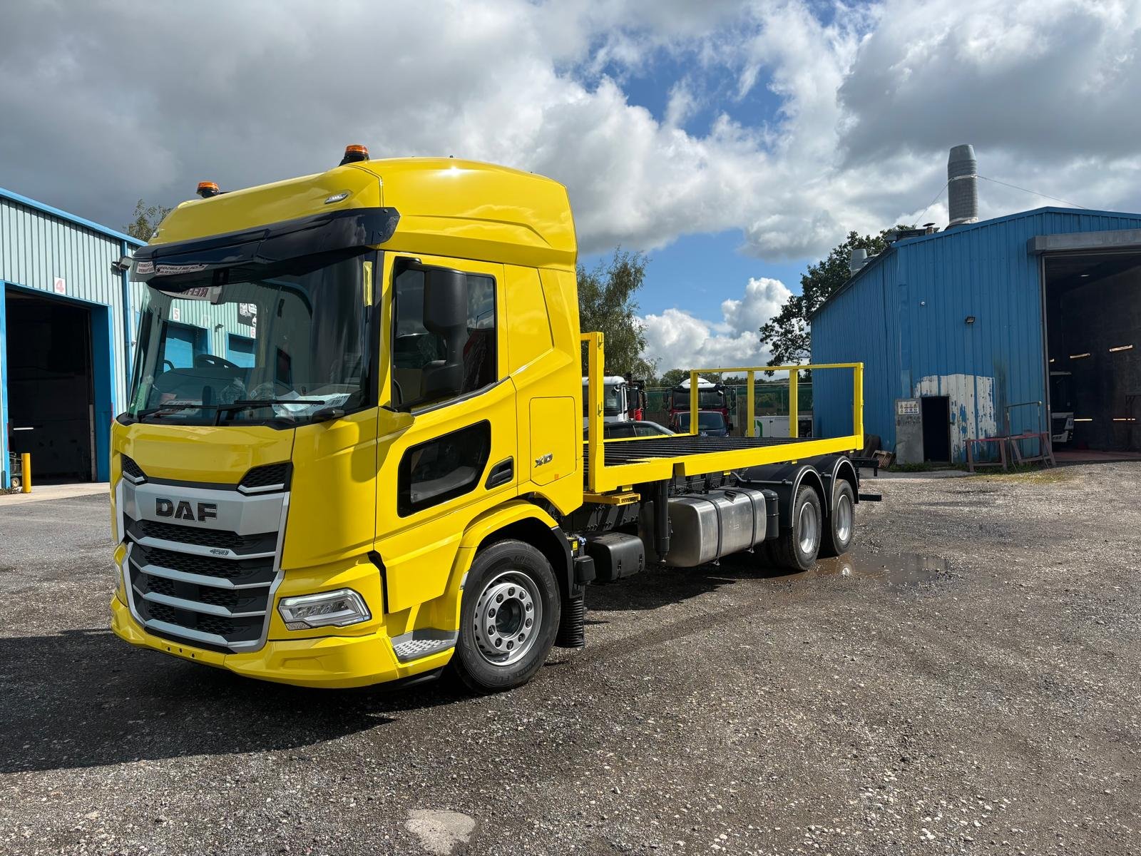 Yellow DAF flatbed commercial vehicle after repainting